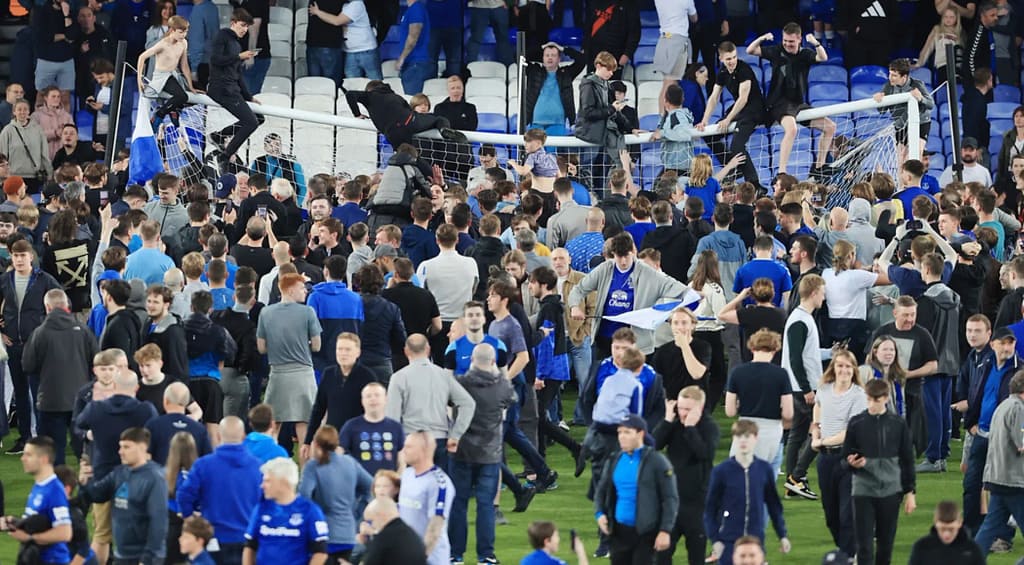 Risks and dangers of football pitch invasions.