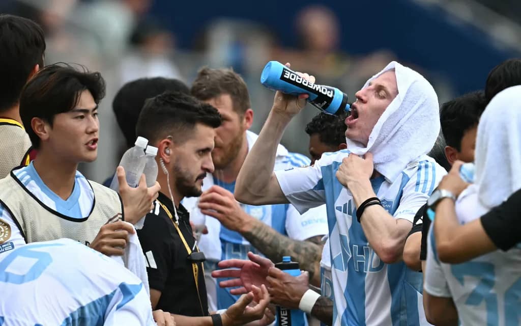 Football players hydrating during a break